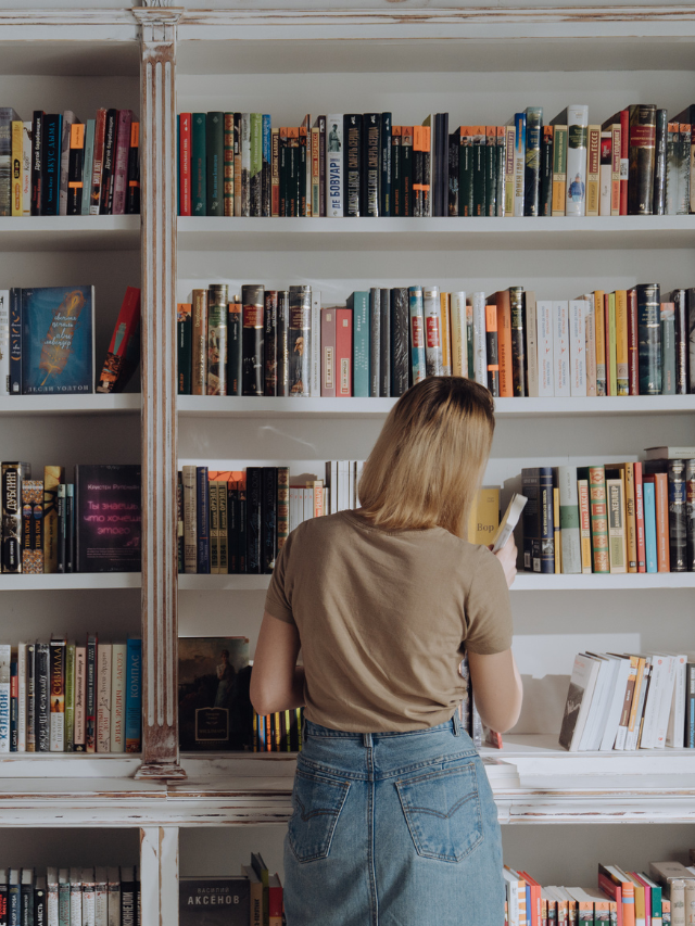 a woman browsing a bookshelf